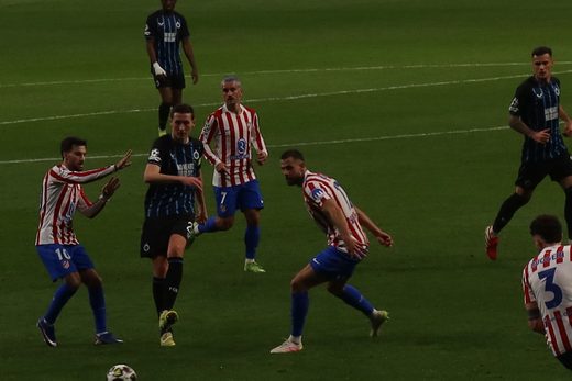 Players contest the ball close to the stands during Atlético de Madrid vs Club Brugge